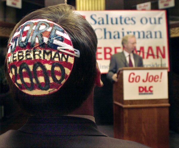 FILE - In this Thursday, Aug. 17, 2000 file photo, Scott Svonkin, vIce chair of the Los Angeles County Commission on Insurance, wears a Gore-Lieberman yarmulke while listening to vice presidential candidate Sen. Joe Lieberman, D-Conn. speak at a Democratic Leadership Council luncheon in Los Angeles. Sanders' model of Jewish American candidacy -- aligning with “the tradition of Jewish social justice” while criticizing Israeli government policy toward Palestinians -- breaks the mold cast by observant Jew Joseph Lieberman, the Democrats’ vice-presidential nominee 20 years ago. (AP Photo/M. Spencer Green)