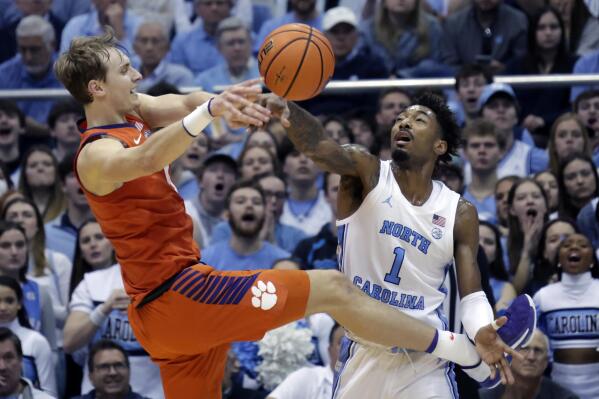 Clemson forward Hunter Tyson, left, has his shot blocked by North Carolina forward Leaky Black (1) during the first half of an NCAA college basketball game, Saturday, Feb. 11, 2023, in Chapel Hill, N.C. (AP Photo/Chris Seward)
