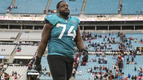 FILE - Jacksonville Jaguars offensive tackle Cam Robinson (74) walks off the field after an NFL football game against the Atlanta Falcons on Nov. 28, 2021, in Jacksonville, Fla.  The NFL suspended Robinson on Thursday, June 29, 2023, for the first four games of the regular season for violating the league's policy on performance-enhancing drugs.  (AP Photo/Gary McCullough, File)