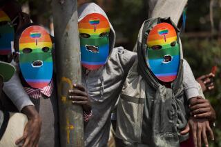 FILE - Kenyan gays and lesbians and others supporting their cause wear masks to preserve their anonymity as they stage a rare protest, against Uganda's tough stance against homosexuality and in solidarity with their counterparts there, outside the Uganda High Commission in Nairobi, Kenya, Feb. 10, 2014. A Ugandan lawmaker on Tuesday, Feb. 28, 2023 introduced draft legislation that he said seeks to further prohibit homosexuality in the East African country, voicing widespread anti-gay sentiment that has peaked in recent days. (AP Photo/Ben Curtis, File)