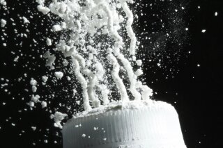 FILE - In this April 19, 2010, file photo, baby powder is squeezed from its bottle in Philadelphia. In a study released on Tuesday, Jan. 7, 2020, U.S. government researchers found no evidence linking baby powder with ovarian cancer in the largest-ever analysis of an issue that has prompted thousands of lawsuits and a recent product recall. (AP Photo/Matt Rourke, File)