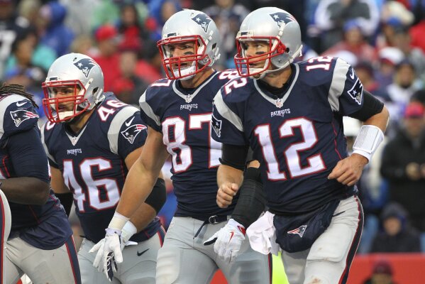 
              FILE - In this Oct. 30, 2016, file photo, New England Patriots' Tom Brady (12), Rob Gronkowski (87) and James Develin (46) head back to the sideline after LeGarrette Blount scored a touchdown during the second half of the team's NFL football game against the Buffalo Bills in Orchard Park, N.Y. Gronkowski says he is retiring from the NFL after nine seasons. Gronkowski announced his decision via a post on Instagram Sunday, March 24, 2019, saying that a few months shy of this 30th birthday “its time to move forward and move forward with a big smile.” (AP Photo/Bill Wippert, File)
            