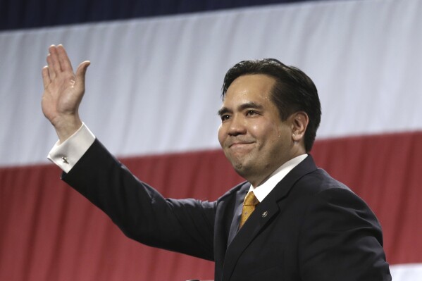 FILE - In this April 25, 2014, file photo, Utah's Attorney General Sean Reyes waves during a rally at the Western Republican Leadership Conference in Sandy, Utah. Utah Attorney General Sean Reyes announced Friday, Dec. 8, 2023 he will not seek reelection in 2024 amid scrutiny for his decadelong friendship with the embattled founder of an anti-child-trafficking group and as bipartisan state lawmakers have cast doubt on his administrative practices..(AP Photo/Rick Bowmer, File)