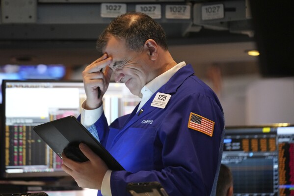 A person works on the floor at the New York Stock Exchange in New York, Monday, March 31, 2025. (AP Photo/Seth Wenig)
