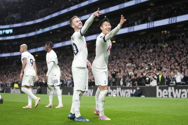 Tottenham's James Maddison, centre, celebrates with Tottenham's Son Heung-min after scoring his side's second goal during the English Premier League soccer match between Tottenham Hotspur and Fulham at the Tottenham Hotspur Stadium in London, Monday, Oct. 23, 2023. (AP Photo/Kin Cheung)