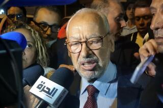 FILE - Leader of the Ennahdha party, Rached Ghannouchi, speaks to the media after he was freed by the Tunisia's anti-terrorism unit in Tunis, Tunisia, Tuesday, July 19, 2022. Influential Tunisian Islamist leader Rachid Ghannouchi was detained Monday after a police search, according to his lawyer. (AP Photo/Hassene Dridi, File)