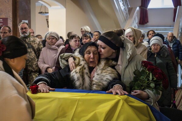 Relatives and friends attend a funeral for Ukrainian soldier Petro Velykiy, who was killed in a battle with the Russian troops in Russia's Kursk region, during a ceremony in Chernyhiv, Ukraine, Nov. 27, 2024. (AP Photo/Dan Bashakov, File)