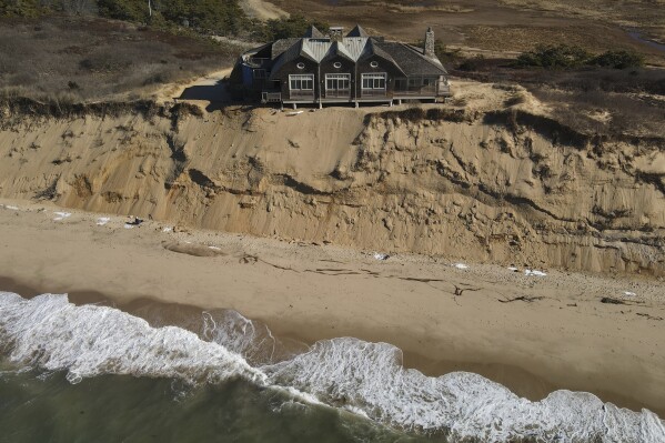 A home sits atop of a sandy bluff overlooking a beach in Wellfleet, Mass., Jan. 27, 2025. (AP Photo/Andre Muggiati, File)