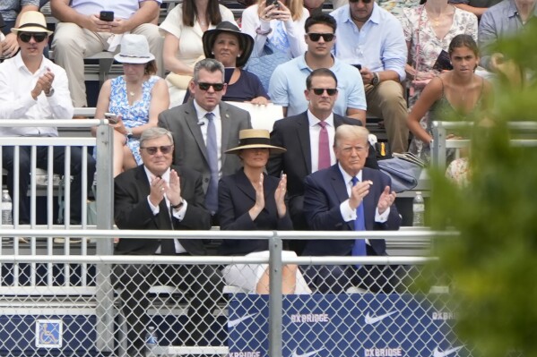 Republican presidential candidate former President Donald Trump, seated right with Melania Trump and her father, Viktor Knavs, attends a graduation ceremony for his son Barron at Oxbridge Academy Friday, May 17, 2024, in West Palm Beach, Fla. (Ǻ Photo/Lynne Sladky)