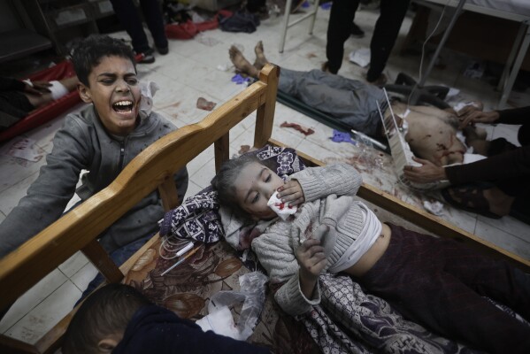 Palestinians wounded in the Israeli bombardment of the Gaza Strip arrive at a hospital in Khan Younis on Friday, Dec. 8, 2023. (AP Photo/Mohammed Dahman)