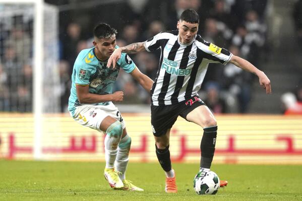 Southampton's Carlos Alcaraz, left, and Newcastle United's Miguel Almiron battle for the ball during their English League Cup Semi Final second leg soccer match at St. James's Park, Newcastle upon Tyne, England, Tuesday, Jan. 31, 2023. (Owen Humphreys/PA via AP)