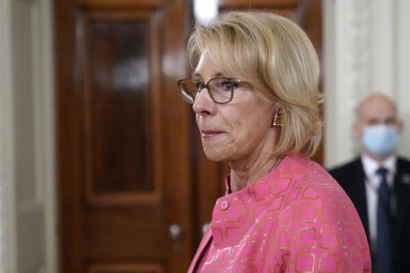 FILE - In this Aug. 12, 2020, file photo Education Secretary Betsy DeVos arrives for an event in the State Dining room of the White House in Washington. As millions of American children start the school year online, the Trump administration is hoping to convert their parents’ frustration and anger into newfound support for school choice policies that DeVos has long championed but struggled to advance nationally.(AP Photo/Andrew Harnik, File)