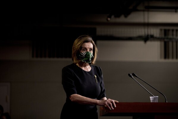 House Speaker Nancy Pelosi of Calif., wears a mask as she steps away from the podium at the conclusion of a news conference on Capitol Hill, Thursday, May 14, 2020, in Washington. (AP Photo/Andrew Harnik)