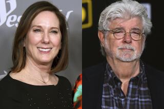 Kathleen Kennedy appears at the 20th annual Costume Designers Guild Awards in Beverly Hills, Calif., on Feb. 20, 2018, left, and George Lucas appears at the premiere of "Solo: A Star Wars Story" in Los Angeles on May 10, 2018.  Kennedy and Lucas, stewards of the "Star Wars" universe are being honored by the Producers Guild of America for their contributions to the film industry. The PGA said Friday, Jan. 14, 2022, that the pair will receive the Milestone Award at the Producers Guild Awards in March. (AP Photo)