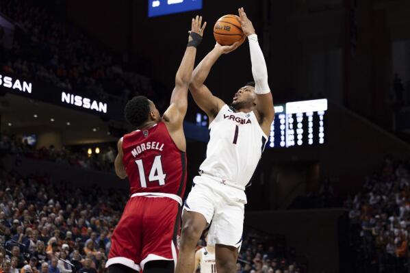 North Carolina State's Casey Morsell (14) defends as Virginia's Jayden Gardner (1) shoots during the second half of an NCAA college basketball game in Charlottesville, Va., Tuesday, Feb. 7, 2023. (AP Photo/Mike Kropf)