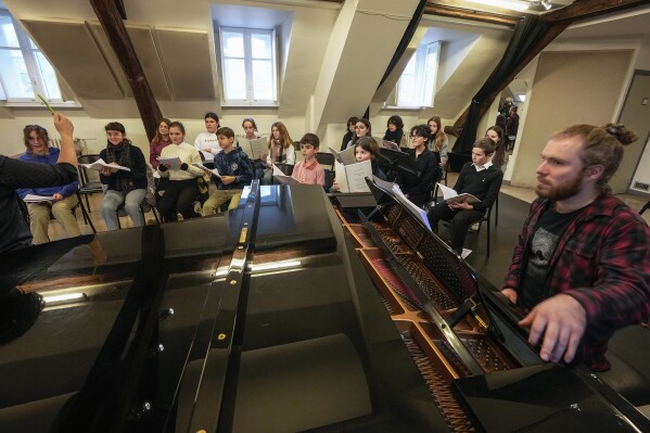 Young choir singers practice on Tuesday, December 5, 2023 in Paris.  The restoration of Notre Dame reaches a milestone on Friday, December 8, 2023: one year until the cathedral reopens its enormous doors to the public.  (AP Photo/Michel Euler)