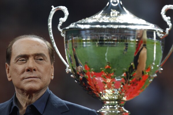 FILE - Italian Premier Silvio Berlusconi attends the presentation of the 'Berlusconi trophy' after a soccer match between AC Milan and Juventus at the San Siro stadium in Milan, Italy, Aug. 21, 2011. From his grand entrance by helicopter after buying AC Milan to empowering Monza up to Serie A for the first time in its history, Silvio Berlusconi dominated Italian soccer for decades just like he commanded the show in Italian politics. Berlusconi, a former three-time Italian premier, died Monday, according to his television network. He was 86. (AP Photo/Luca Bruno, File)