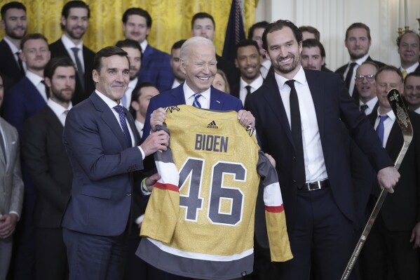 President Joe Biden holds a jersey during an event to celebrate the Vegas Golden Knights in their 2023 Stanley Cup victory in the East Room of the White House, Monday, Nov. 13, 2023, in Washington. (AP Photo/Andrew Harnik)