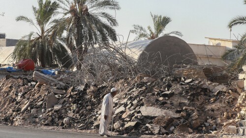 A man walks past the rubble of a demolished al-Siraji Mosque in Basra, Iraq, on Monday, July 17, 2023. An official said the old mosque would be replaced with a modern, better-designed one that would not impede traffic flow. (AP Photo/Nabil al-Jurani)