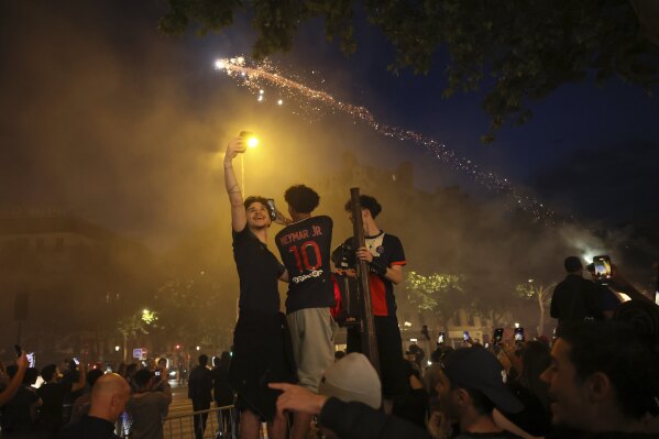 PSG supporters celebrate during the Champions League final soccer match between Paris Saint-Germain and Inter Milan, Saturday, May 31, 2025 in Paris. (AP Photo/Thomas Padilla)