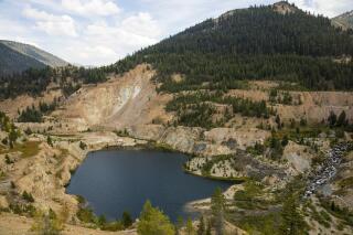 FILE - The Yellow Pine Pit open-pit gold mine is shown on Sept. 19, 2018, in the Stibnite Mining District in central Idaho. The Nez Perce Tribe and two conservation groups say Idaho officials violated the Clean Air Act as well as the state's regulations by issuing an air quality permit for a proposed gold mine in west-central Idaho. (Riley Bunch/Idaho Press-Tribune via AP, File)