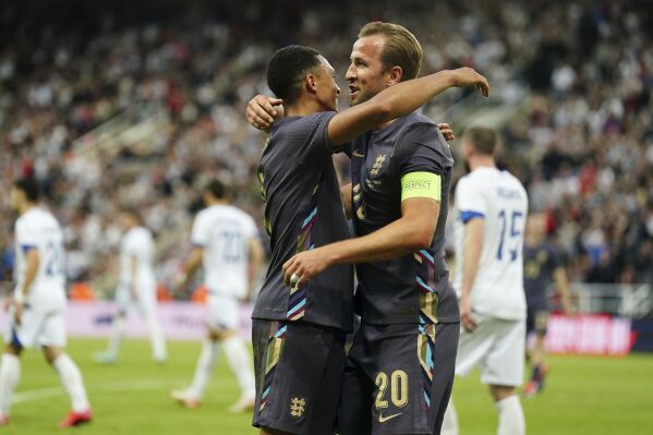 England's Trent Alexander-Arnold celebrates scoring with Harry Kane, right, during an international friendly soccer match between England and Bosnia and Herzegovina at St. James Park in Newcastle, England, Monday, June 3, 2024. (Mike Egerton/PA via AP)