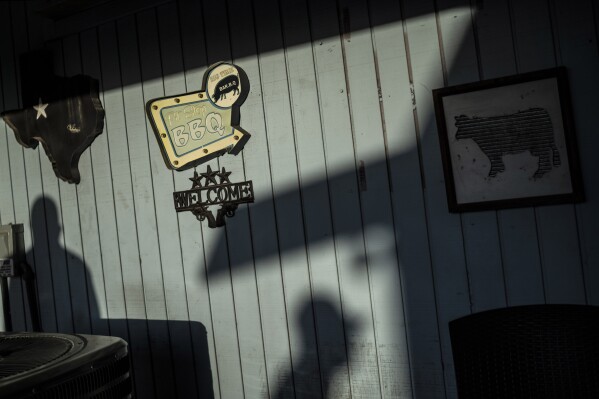 A customer walks up to place an order at Valentina's Tex Mex BBQ restaurant in Austin, Texas, Saturday, April 22, 2023. Later in the year, the restaurant re-opened in Buda, a suburb south of the capital. Texas is home to more cattle than any other state and accounts for about 15% of beef cattle in the nation. (AP Photo/David Goldman)