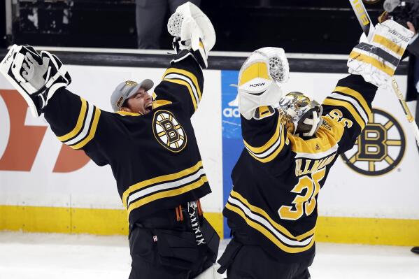 Boston Bruins' Linus Ullmark (35) and Jeremy Swayman celebrate the team's win over the New Jersey Devils in an NHL hockey game, Saturday, April 8, 2023, in Boston. (AP Photo/Michael Dwyer)