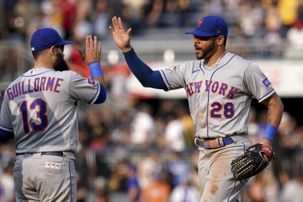 New York Mets shortstop Luis Guillorme and left fielder Tommy Pham celebrate after defeating the Pittsburgh Pirates in a baseball game in Pittsburgh, Saturday, June 10, 2023. (AP Photo/Matt Freed)