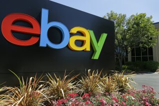 FILE - This Tuesday, July 16, 2013, file photo shows signage at eBay headquarters in San Jose, Calif. Six former eBay Inc. employees were arrested and charged Monday, June 15, 2020, with waging an extensive campaign to terrorize and intimidate the editor and publisher of an online newsletter with threats and disturbing deliveries to their home, including live spiders and cockroaches. (AP Photo/Ben Margot, File)