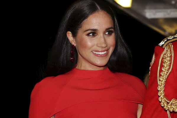 FILE - In this Saturday March 7, 2020 file photo, Meghan, Duchess of Sussex with Prince Harry arrives at the Royal Albert Hall in London, to attend the Mountbatten Festival of Music. A British newspaper doesn’t have to run a front-page statement about the Duchess of Sussex’s legal victory until it has had the chance to challenge the order, a judge ruled Monday March 22, 2021. (Simon Dawson/Pool via AP, File)