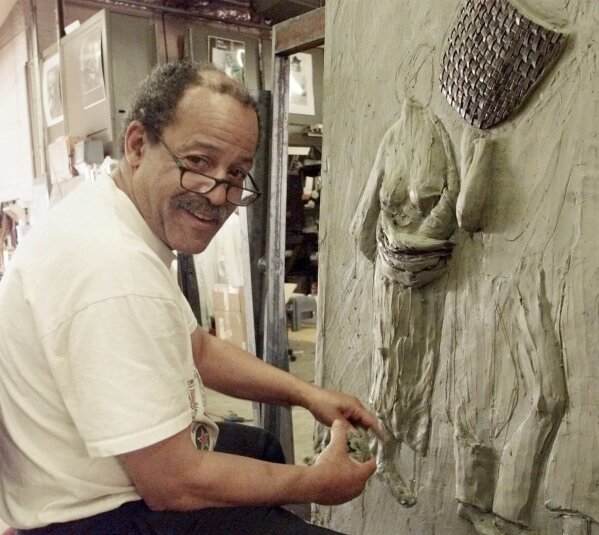 FILE - Sculptor and former astronaut Ed Dwight works on a piece in his studio in Denver, Colo., on Aug. 5, 1999. Dwight is featured in a documentary 鈥淭he Space Race," which chronicles the stories of Black astronauts. (AP Photo/Ed Andrieski, File)