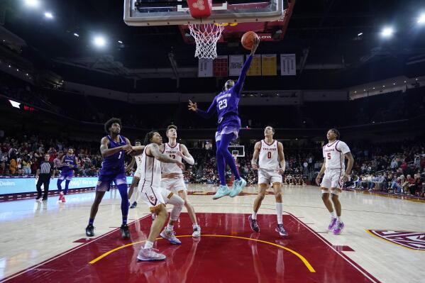 Washington guard Keyon Menifield (23) scores against Southern California during the second half of an NCAA college basketball game Saturday, Feb. 4, 2023, in Los Angeles. (AP Photo/Marcio Jose Sanchez)