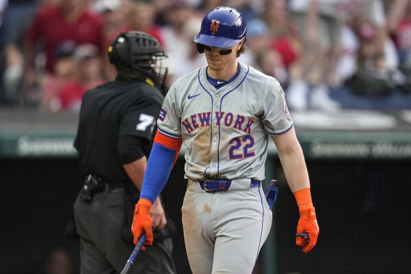 New York Mets' Brett Baty (22) walks back to the dugout after striking out in the sixth inning of a baseball game against the Cleveland Guardians, Monday, May 20, 2024, in Cleveland. (AP Photo/Sue Ogrocki)