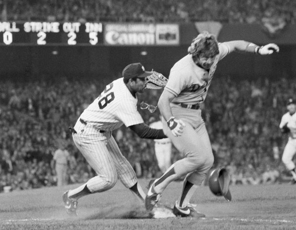 FILE - In this October 1981 file photo, Los Angeles Dodgers' Steve Yeager, right, and New York Yankees first baseman Bob Watson collide during a close play at first base in the fifth inning of a World Series baseball game in New York. Yeager lined a ball off Yankees pitcher Tommy John's glove, who recovered to throw to Watson for the tag. Watson held on the ball and Yeager was out on the play to end the inning. Watson, a two-time All-Star as a player who later became the first African American general manager to win a World Series with the Yankees in 1996, has died. He was 74. (AP Photo, File)