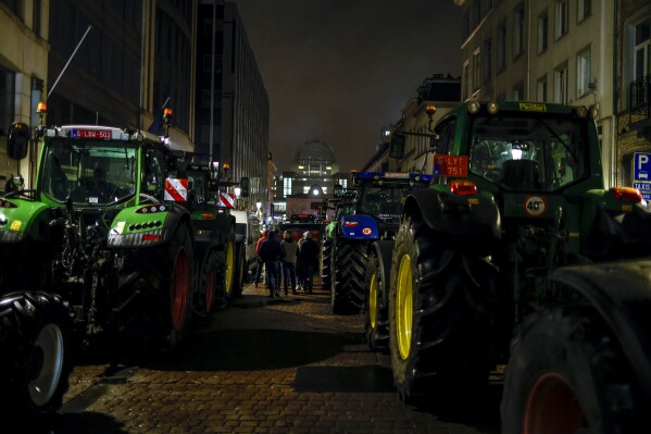Tractors are parked as farmers gather for a protest outside the European Parliament ahead of an EU summit in Brussels, Thursday, Feb. 1, 2024. (AP Photo/Omar Havana)