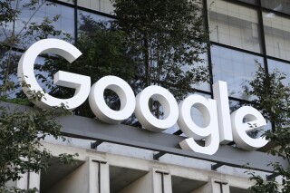 FILE - The Google sign hands over an entrance to the company's new building, Sept. 6, 2023, in New York. Search giant Google has agreed to a $93 million settlement with the state of California on Thursday, Sept. 14, over the its location-privacy practices. (AP Photo/Peter Morgan, File)