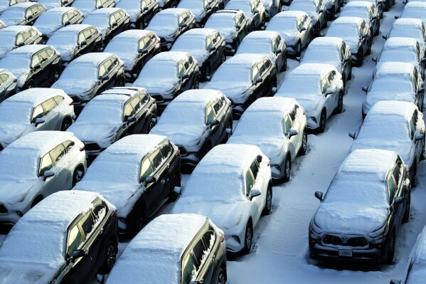 Snow-covered vehicles sit in a rental car parking lot at Chicago's O'Hare International Airport on Sunday, Jan. 14, 2024.  A wind chill warning is in effect as dangerously cold conditions continue in the Chicago area.  (AP Photo/Nam Y. Huh)