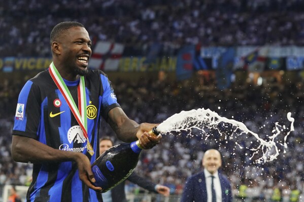 Inter's Marcus Thuram celebrates their victory of the "scudetto" after the Serie A soccer match between Inter and Lazio at the San Siro Stadium in Milan, Italy, Sunday, May 19, 2024. (Spada/LaPresse via AP)