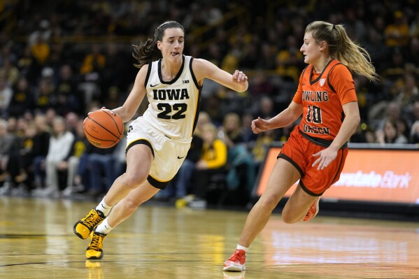 Iowa guard Caitlin Clark (22) drives past Bowling Green guard Paige Kohler (10) during the first half of an NCAA college basketball game, Saturday, Dec. 2, 2023, in Iowa City, Iowa. (AP Photo/Charlie Neibergall)