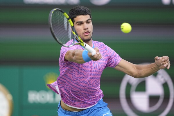 Carlos Alcaraz, of Spain, returns to Alexander Zverev, of Germany, during a quarterfinal match at the BNP Paribas Open tennis tournament, Thursday, March 14, 2024, in Indian Wells, Calif. (AP Photo/Mark J. Terrill)