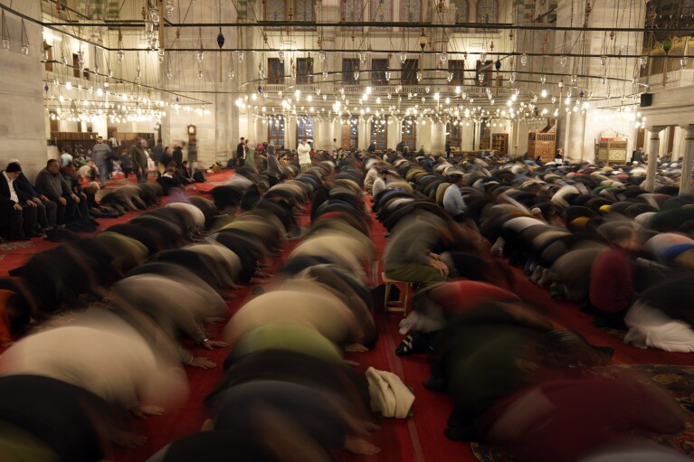 Muslim worshippers perform a night prayer called 'Tarawih' on the first day of the Muslim holy month of Ramadan, at Fatih mosque in Istanbul, Turkey, Monday, March 11, 2024. (AP Photo/Khalil Hamra)
