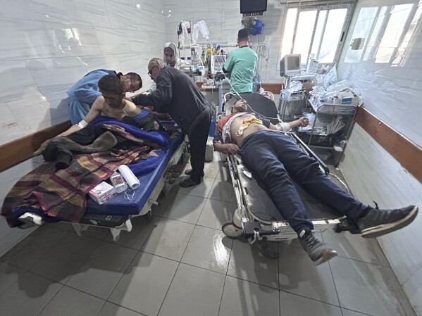 Palestinians wounded in an Israeli strike while waiting for humanitarian aid on the beach in Gaza City are treated in Shifa Hospital in Gaza City, Thursday, Feb. 29, 2024. (AP Photo/Mahmoud Essa)