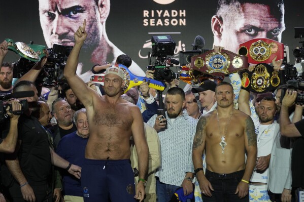 Heavyweight boxers Britain's Tyson Fury, left, and Ukraine's Oleksandr Usyk stand on the stage during the weigh-in in Riyadh, Saudi Arabia, Friday, May 17, 2024, prior to their undisputed heavyweight championship fight on Saturday. (AP Photo/Francisco Seco)