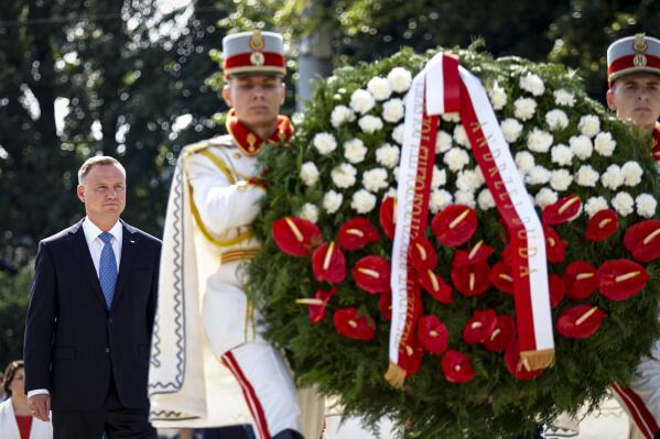Poland's President Andrzej Duda walks behind honor guards carrying wreaths during an event held to celebrate Moldova's national day, three decades after the country declared independence from the Soviet Union, in Chisinau, Moldova, Friday, Aug. 27, 2021. The 30-year anniversary event was held in the capital's Grand National Assembly Square where President Maia Sandu was joined by Poland's President Andrzej Duda, Ukraine's President Volodymyr Zelenskyy and Romania's President Klaus Iohannis (AP Photo/Aurel Obreja)
