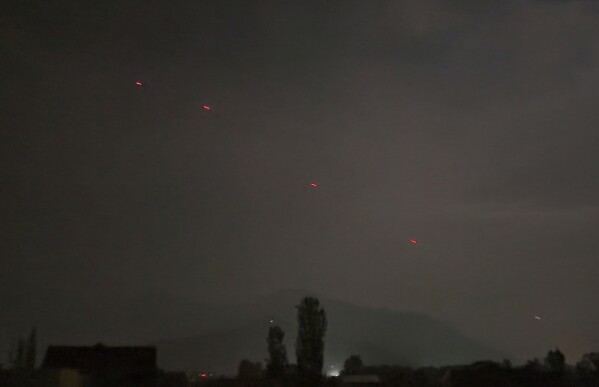 Red projectiles are seen over Srinagar, in Indian controlled Kashmir, Saturday, May 10, 2025. (AP Photo/Mukhtar Khan)