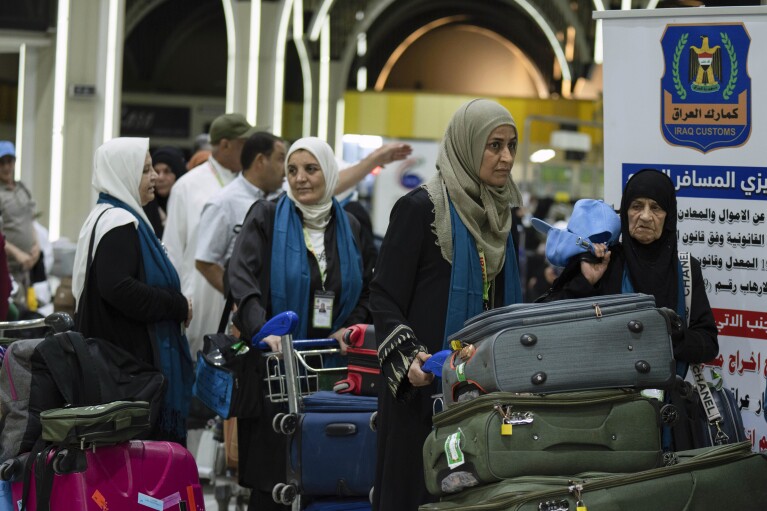 Iraqi pilgrims are heading to Mecca for Haj, the holiest place in Islam, at the Baghdad Airport in Baghdad, Iraq, Wednesday, June 7, 2023. (AP Photo/ Hadi Mizban)