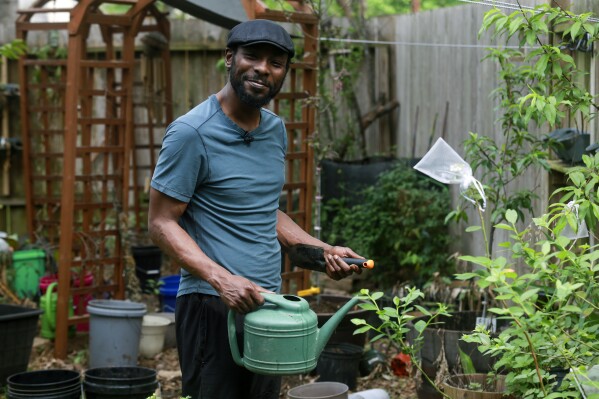 Marcus Bridgewater poses for a portrait, Thursday, March 14, 2024, at his home in Spring, Texas. (AP Photo/Lekan Oyekanmi)