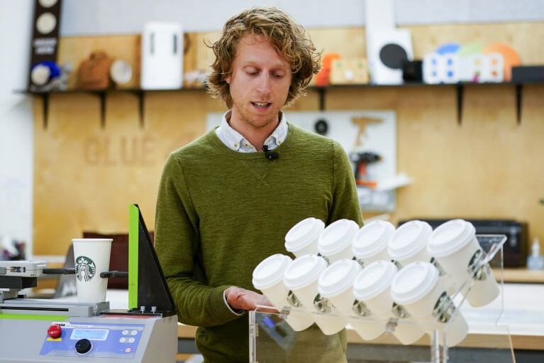 Senior Packaging Engineer Kyle Walker explains a tilt test for cups at the Tryer Center at Starbucks headquarters, Wednesday, June 28, 2023, in Seattle. (AP Photo/Lindsey Wasson)