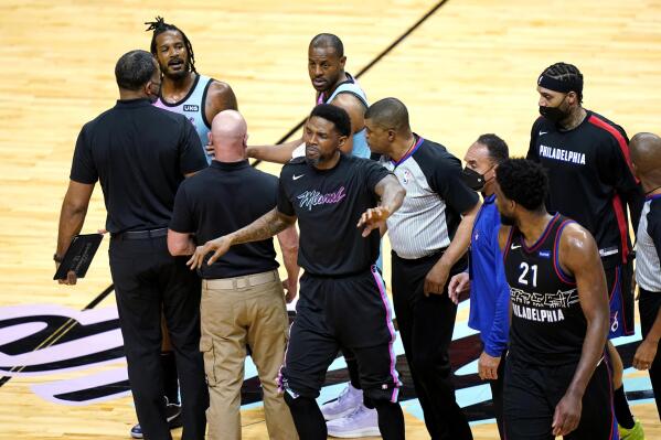 Miami Heat forward Udonis Haslem, center, gestures near Philadelphia 76ers center Joel Embiid (21) after Heat forward Trevor Ariza, left, was called for a foul during the first half of an NBA basketball game Thursday, May 13, 2021, in Miami. (AP Photo/Lynne Sladky)